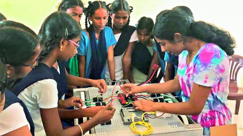 Niharika educates about robotics to the students of ZP High School at Muthukur.
