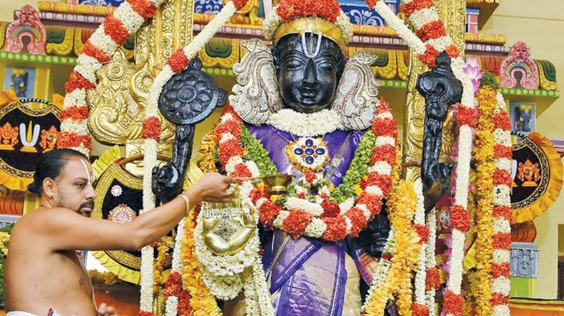 Decked in blue silk robes and adorned with flowers, Athi Varadars standing posture enthralled  devotees in Kancheepuram on Thurday. (Photo: DC)