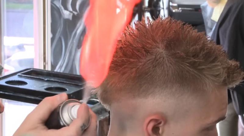Man gets his hair styled with fire. (Photo: Youtube)