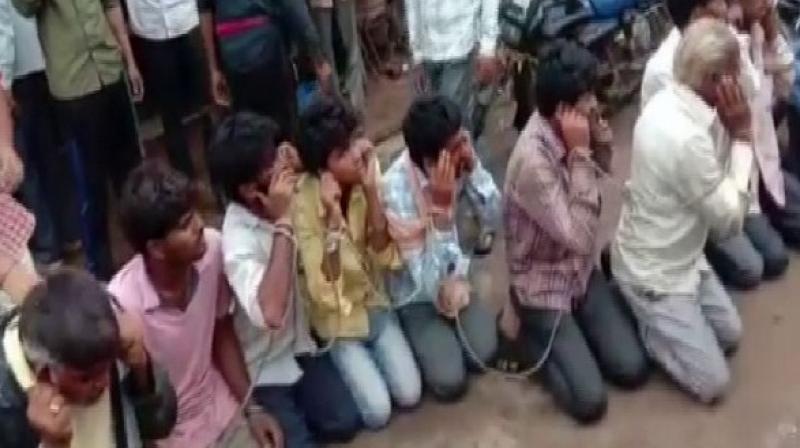In a video which has gone viral, they were tied to a rope in public, made to kneel down and forced to chant \Gau Mata ki Jai\ by the side of a road. (Photo: ANI)