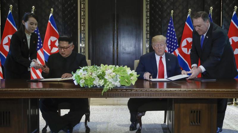 North Korea leader Kim Jong Un and US President Donald Trump sign a document at the Capella resort on Sentosa Island on Tuesday in Singapore. (Photo: AP)