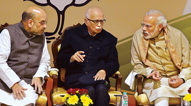 Prime Minister Narendra Modi (from R) with senior BJP leader L.K. Advani and BJP president Amit Shah at the partys National Executive Meet in New Delhi on Friday. (Photo: PTI)