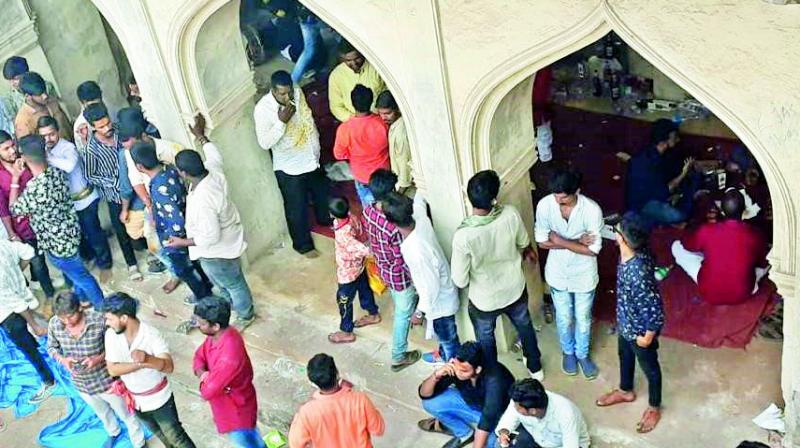 People gather at an unused mosque in Golconda Fort on Tuesday after reports on social media suggested some people were sitting there with liquor bottles. (Photo: DC)