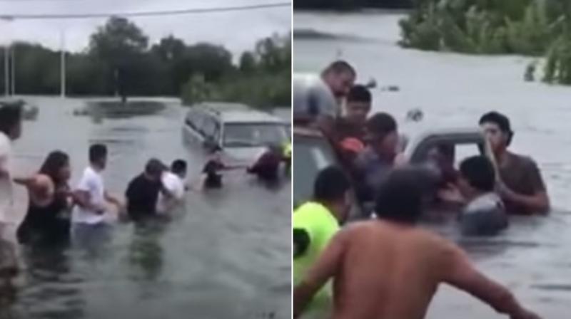 Human chain saves man trapped in car by floods in Texas. (Photo: Youtube)