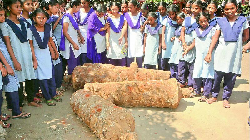 Children look at cannons from the British era unearthed at Queen Marys High School on Thursday. (Photo: DC)