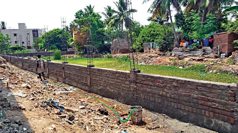 Compound wall being constructed around Mugalivakkam pond would help conserve water for the residents. (Photo: DC)
