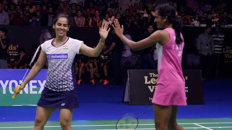 Saina Nehwal and PV Sindhu joined hands to beat Lin Dan and Lee Chong Wei 5-4 in a doubles exhibition game. (Photo: PTI)