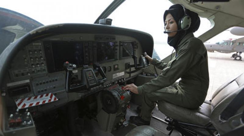 Safia Ferozi, 26, sits in a C-208, a turboprop plane used as transport for the armed forces, before a flight, at the Afghan military airbase in Kabul. (Photo: AP)