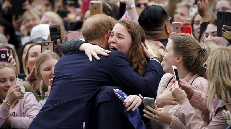 Britains Prince Harry hugs a member of the public as he arrives at the Royal Botanic Gardens in Melbourne, Australia, Thursday, Oct. 18, 2018. (Photo: AP)