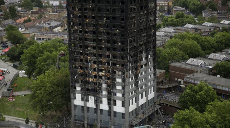 London firefighters combed through the burned-out public housing tower Thursday in a grim search for missing people as police and the prime minister launched investigations into the deadly inferno, with pressure building on officials to explain the disaster and assure that similar buildings around the country are safe. (Photo: AP)