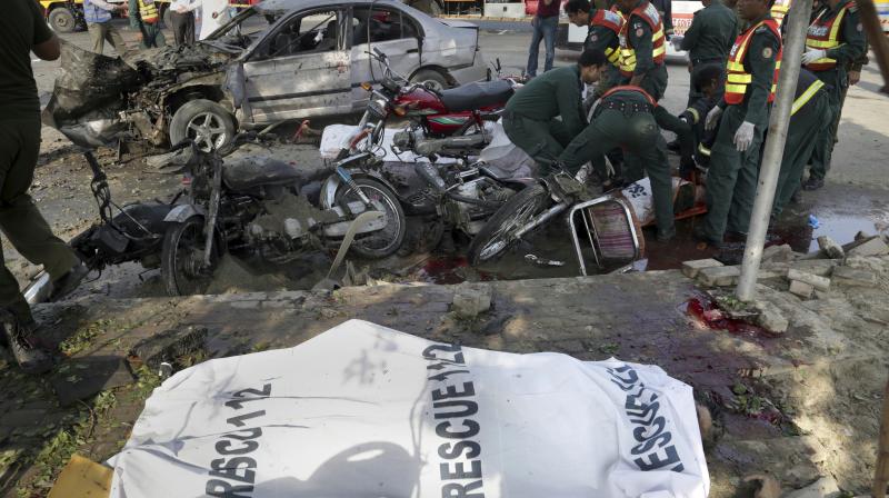 Pakistani rescue workers remove a body from the site of bombing in the eastern city of Lahore, Pakistan. (Photo: AP)