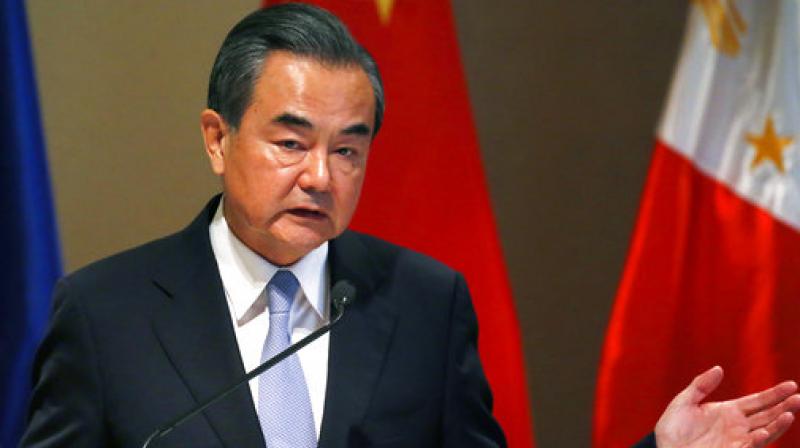 Chinese Foreign Minister Wang Yi gestures during a joint news conference with Philippine Foreign Affairs Secretary Alan Peter Cayetano following their bilateral meeting in suburban Taguig city, east of Manila, Philippines. (Photo: AP)