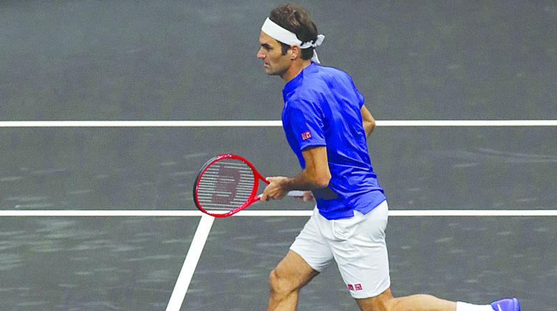 Team Europes Roger Federer action against Team Worlds Jack Sock and Kevin Anderson during a Laver Cup doubles match in Chicago on Friday.  (Photo:AP)