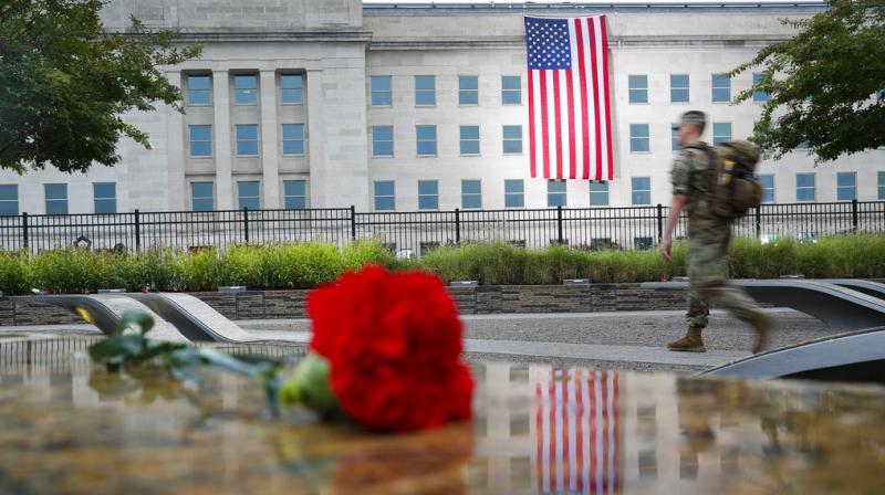 A member of the military walks the grounds of the National 9/11 Pentagon Memorial before the start of the September 11th Pentagon Memorial Observance at the Pentagon on the 17th anniversary of the September 11th attacks. (Photo: AP)