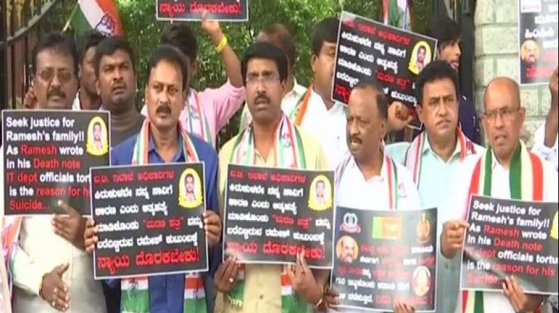 While one placard sought justice for the deceased and the other accused government of targeting the leaders to take the political revenge. (Photo: ANI)