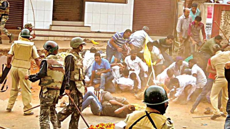 A file photo of police caning participants in a procession which turned violent during Tipu Jayanti in Madikeri last year