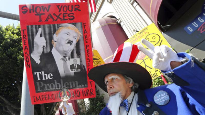 Tax Day Rallies: American demonstrators demand to know Trumps tax returns