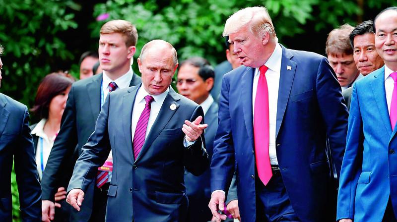 US President Donald Trump (right) and Russias President Vladimir Putin chat as they walk together to take part in the  family photo  during the Asia-Pacific Economic Cooperation leaders summit in the Vietnamese city of Danang. (Photo:  AFP)