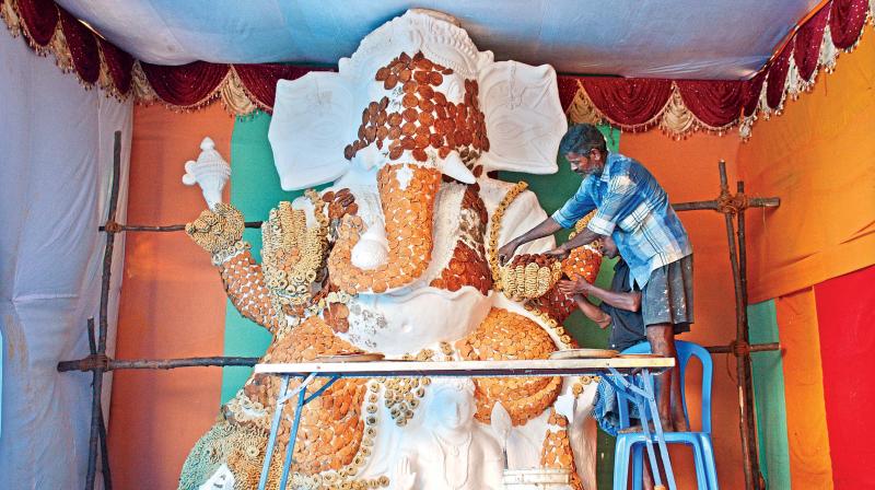 A gigantic image of Lord Ganesh made with 500 kg of sweets is getting readied at T Nagar in Chennai ahead of Vinayaka Chathurti festival on Thursday.   Image:  DC