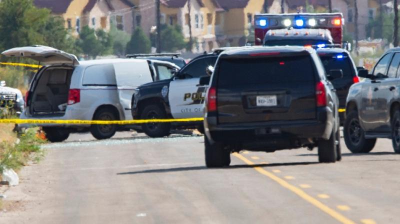 Law enforcement officials surrounding a white van behind the Cinergy Odessa entertainment complex in Odessa, Tex., where the suspect was confronted by the police and was killed. (Photo: AP)