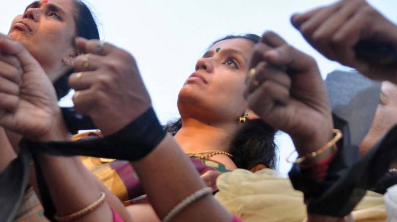 Women lock their hands with a cloth at the Gandhi Square in Kochi on Saturday in protest against the brutal way in which tribal youth Madhu was killed in Attappadi the other day. (Photo: SUNOJ NINAN MATHEW.)