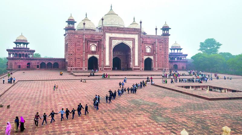 Students line up in front of the mosque from the main tomb of Taj Mahal, Agra; (Below) Dhobi ghat at Varanasi; (Inset) Photographer Prathap DK