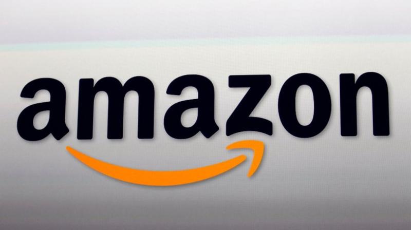 This file photo shows the Amazon logo. Amazon said that it has more than 100 million paid Prime members, the first time the company has given out a specific number on its paid subscriber base. (AP Photo/Reed Saxon, File)