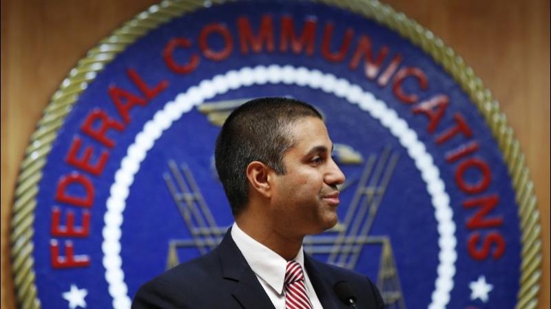 After a meeting voting to end net neutrality, Federal Communications Commission (FCC) Chairman Ajit Pai smiles while listening to a question from a reporter in Washington. The FCC has set June 11 as the repeal date for â€œnet neutralityâ€ rules meant to prevent broadband companies from exercising more control over what people watch and see on the internet. (AP Photo/Jacquelyn Martin, File)