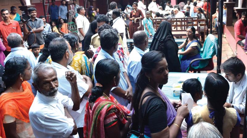 Patients wait for their turn at OP being conducted in an open place at the General Hospital in Thiruvananthapuram on Monday. (Photo: Peethambaran Payyeri)