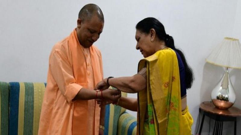 Governor Anandiben Patel ties rakhi to UP CM Yogi Adityanath