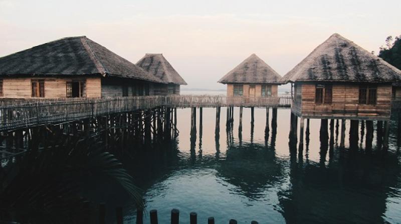 15 Telunas beach resort villas branch out on stilts over the water, resembling a local water village or kampung. 