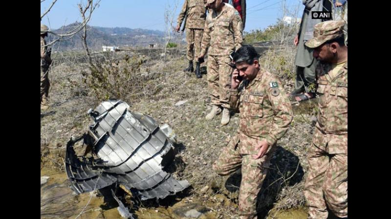 Wreckage of the F-16 Pakistan Air Force jet, which was shot down by the Indian Air Force on Wednesday, was seen being inspected by Pakistan military officers in PoK, sources said. (Photo: ANI)