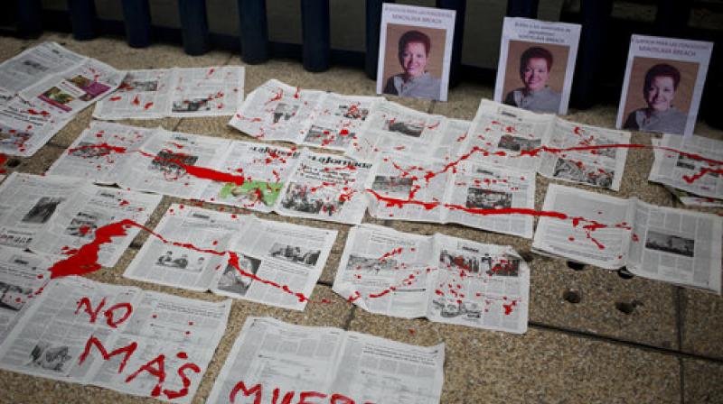 â€œNo More Deathsâ€ is written in red paint on newspapers placed in front of photos of Mexican journalist Miroslava Breach, who was gunned down in the northern state of Chihuahua (Photo: AP)