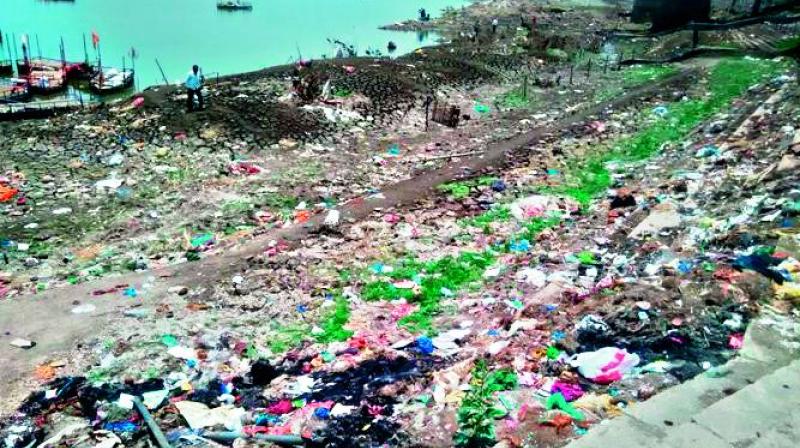 A view of garabage, pastic waste and other wastes strewn across the pushkara ghat at Basar on the banks of river Godavari.   (Photo: DC)