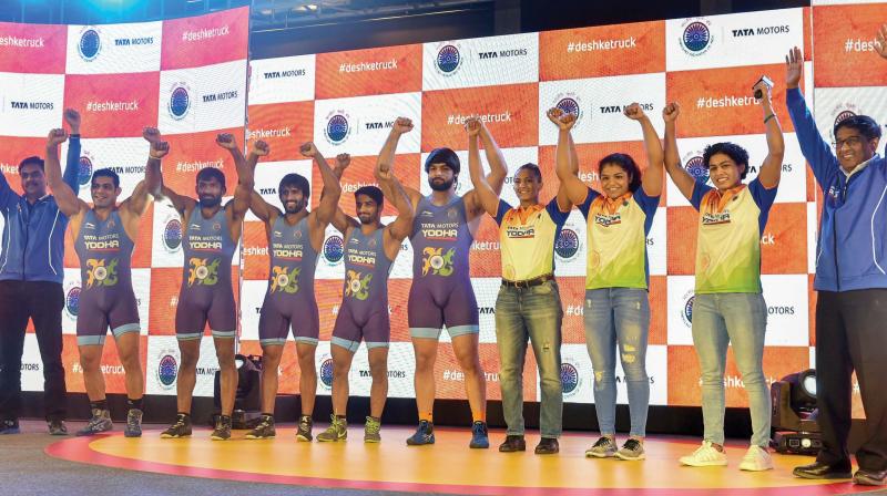 Indian wrestlers Sushil Kumar (from left), Yogeshwar Dutt, Bajrang Punia, Sandeep Tomar, Satyawart Kadian, Geeta Phogat, Sakshi Malik and Pooja Dhanda pose during an event in in Mumbai on Wednesday. (Photo: AP)