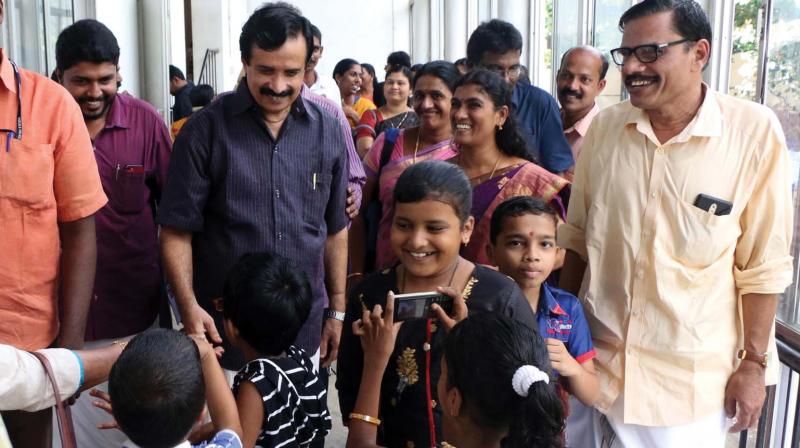 Education minister Prof C Raveendranath interacts with  differently-abled children at Kozhikode on Friday. (Photo: Venugopal)