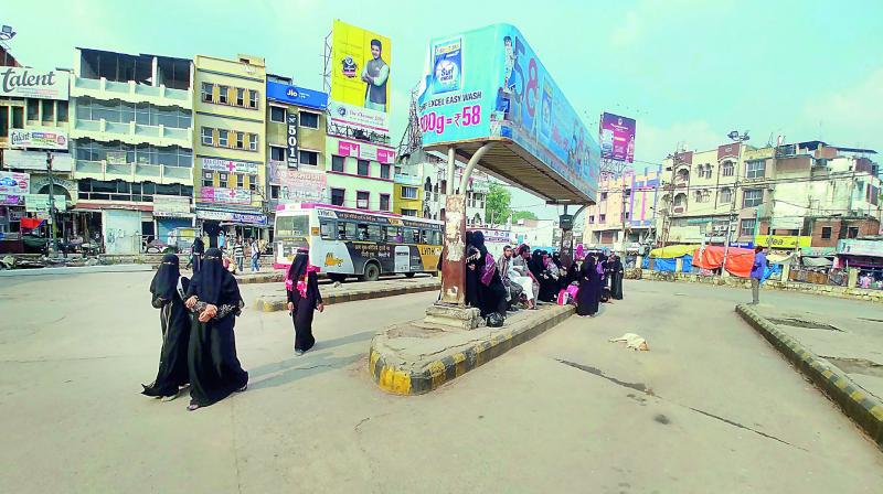 Passengers wait for buses at Charminar bus stand. (Photo: DC)