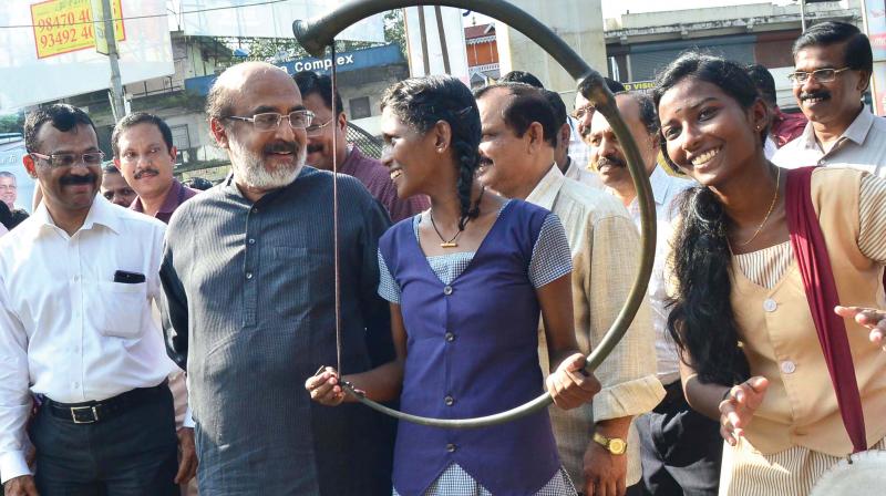 Finance minister Dr. T.M. Thomas Isaac exchanging pleasantries with a girl, member of the percussion team during the reception accorded to him. The minister was in Kochi to inaugurate the zonal meeting of Kerala State Financial Enterprises officials at Ernakulam Town Hall on Monday. (Photo: DC)