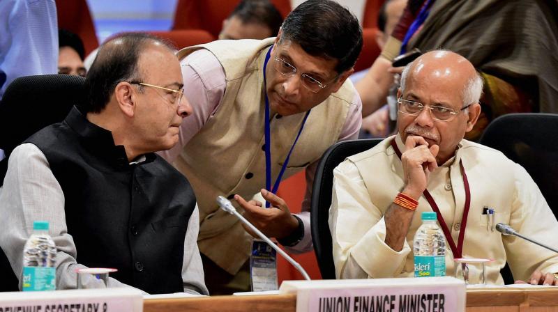 Union finance minister Arun Jaitley listens to Chief economic advisor Arvind Subramaniam as minister of state for finance Shiv Pratap Shukla looks on, at the 22nd meeting of the GST council, in New Delhi on Friday. 	(Photo: PTI)