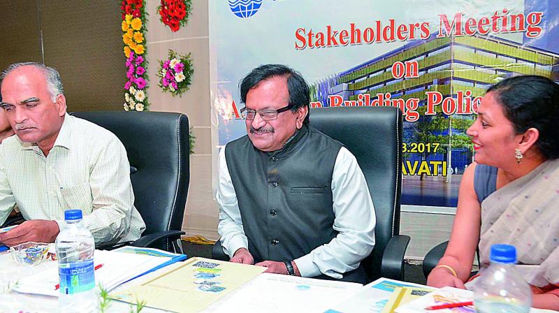 AP Pollution Control Board chairman G. Phani Kumar shares a word with CSC director Anumitharoy Chowdary at the stakeholders meeting in Vijayawada on Thursday. Member secretary B.S.N. Prasad is also seen. (Photo: DC)