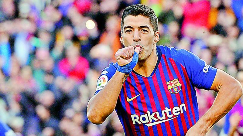 Barcelonas Luis Suarez celebrates a goal against Real Madrid during their Spanish league match at the Camp Nou on Sunday.  (Photo:AFP)