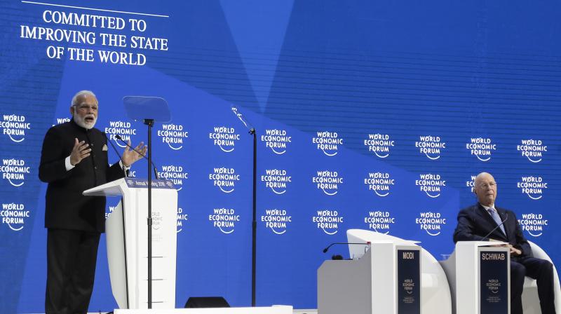 PM Modi delivers his speech as Klaus Schwab, Founder and Executive Chairman of the World Economic Forum listens during the opening session of the World Economic Forum, WEF, in Davos, Switzerland. (Photo: AP)