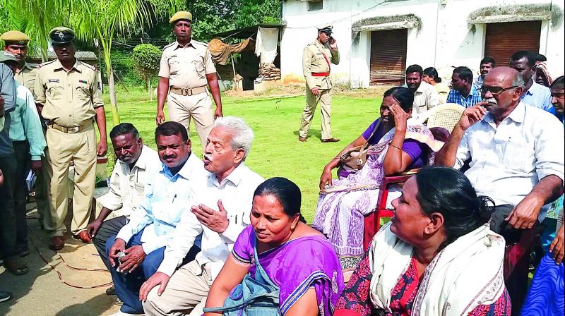 Varavara Rao (sitting 3rd from the left in the front row) with family members of slain Maoists in Malkangiri on Wednesday.