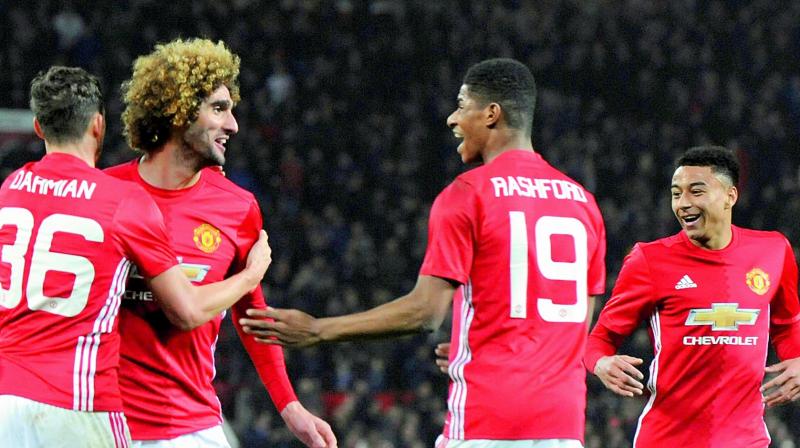 Manchester Uniteds Marouane Fellaini (second left) celebrates with teammates after scoring his sides second goal during the English League Cup semifinal first leg against Hull City at Old Trafford stadium in Manchester on Wednesday. (Photo: AP)