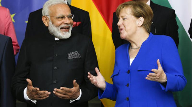 Prime Minister Narendra Modi and German Chancellor Angela Merkel. (Photo: Twitter | ANI)