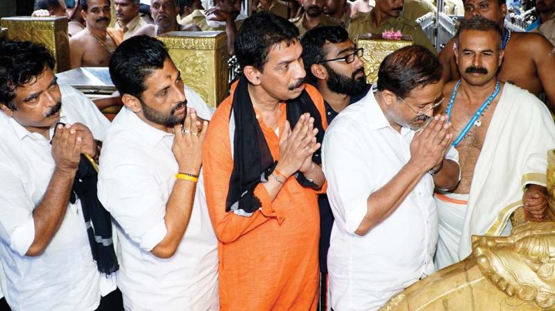 BJP MP V. Muraleedharan and other party leaders pray at Sabarimala Shrine on Tuesday.