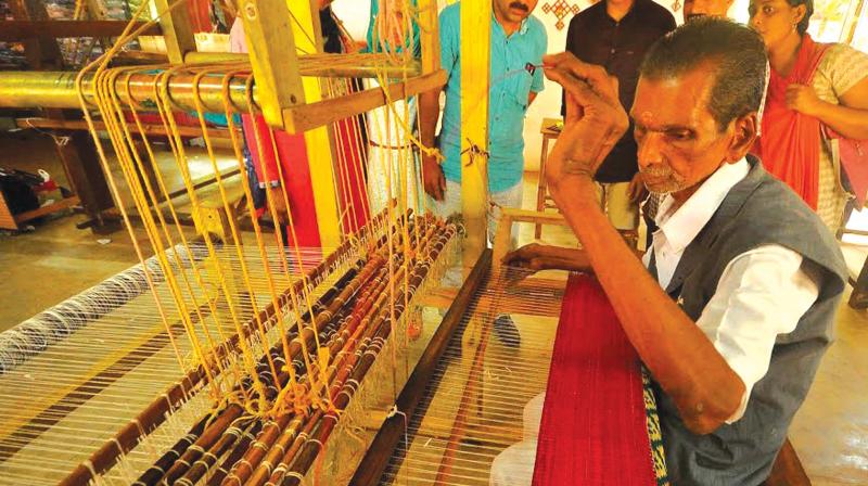 NC Ayyappan working on the kora mats at Irigal Sargaalaya Craft Village as part of the International Crafts Expo on Thursday. (Photo: DC)