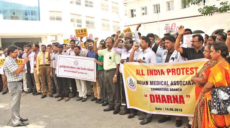 Doctors from Indian Medical Association (IMA) and Tamil Nadu Government Doctors Association stage a dharna in front of the Coimbatore government hospital to protest against the assault of a junior doctor in Kolkata.  (DC)