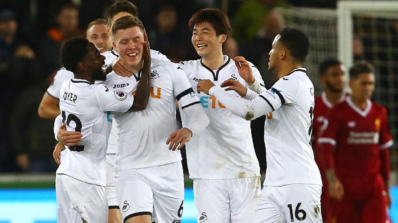 Swansea took the lead against the run of play just before half-time when Mawson swept the ball in from a corner after Van Dijk failed to head clear. (Photo: AFP)