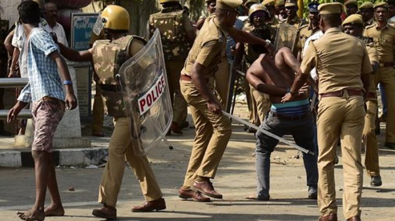Police lathicharge to disperse protesters during a violent clash with the police near Marina Beach in Chennai. (Photo: AP)